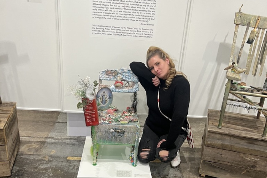 Aimee Wissman with art at Home Free in Akron.
