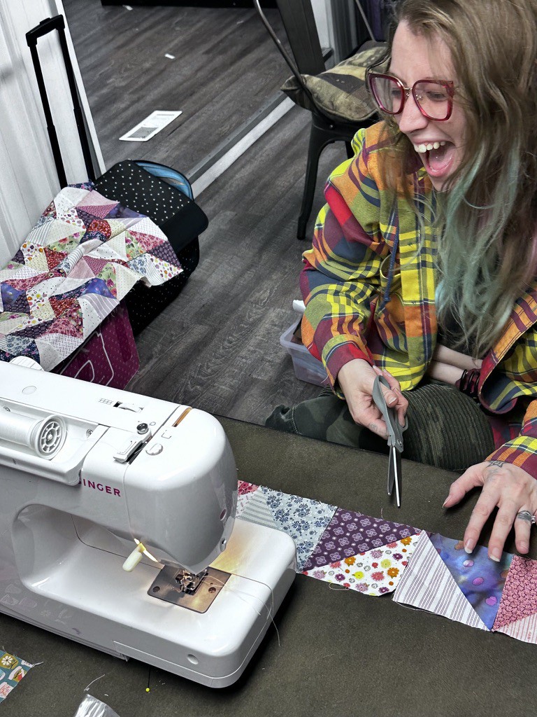 A formerly incarcerated artist sews at a retreat with the Returning Artists Guild in Ohio.